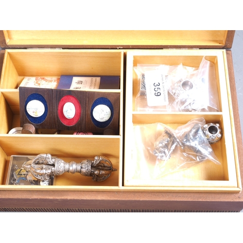 359 - A walnut jewel box, three enamel pill boxes, a collection of enamel charms, etc