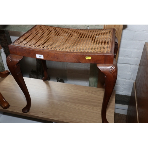 568 - A 1930s carved walnut dressing stool with cane seat, on cabriole supports, 24