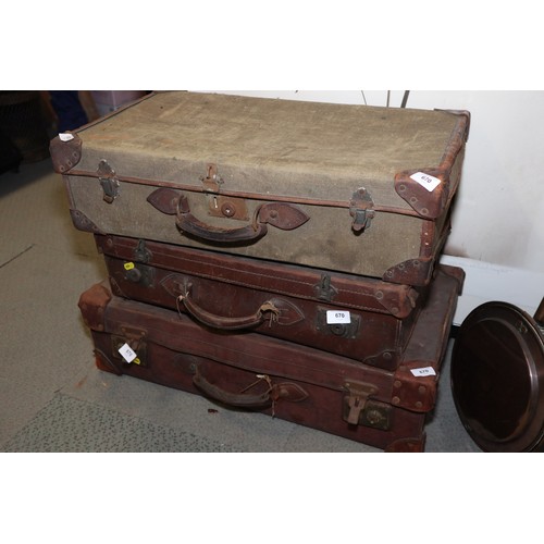 670 - Two leather suitcases and a canvas suitcase