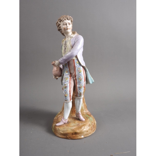 8 - A German porcelain figure/spill vase, formed as a young man holding a jug, 11