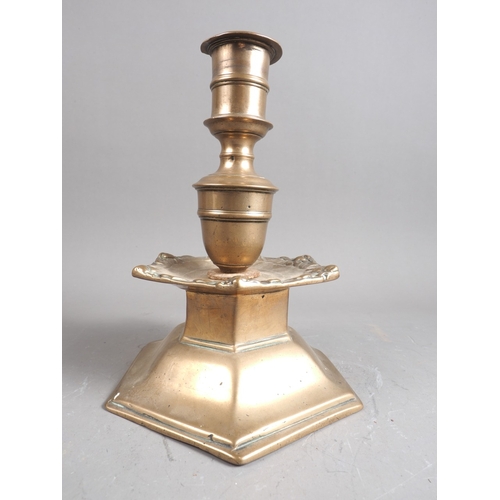 116 - A 17th century Spanish/Scandinavian bronze candlestick with hexagonal base and cherub decorated drip... 