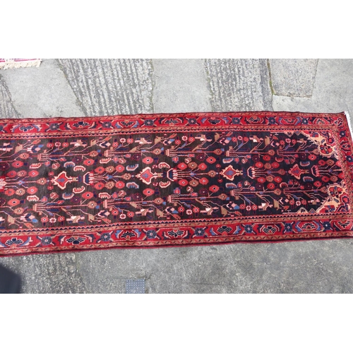 614 - A Persian Nahavan wool runner of traditional design, on a deep ground, 126