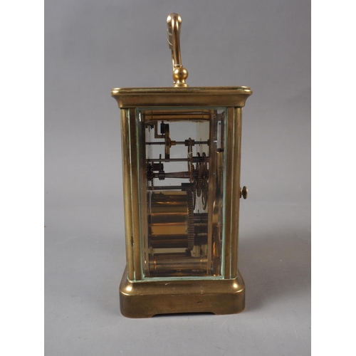 111 - A late 19th century brass cased carriage clock with enamelled dial, inscribed to 