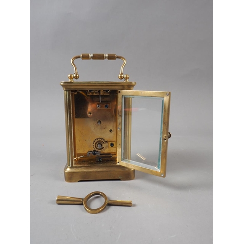 111 - A late 19th century brass cased carriage clock with enamelled dial, inscribed to 