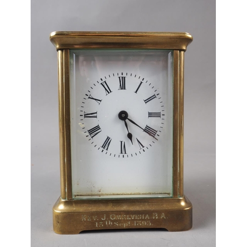 111 - A late 19th century brass cased carriage clock with enamelled dial, inscribed to 