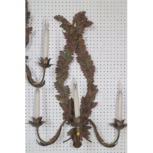 244 - A pair of painted stamped metal, oak and laurel leaf three-light wall brackets, 28