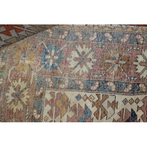 617 - A Persian tribal rug with all-over geometric design, on a cream ground, 52