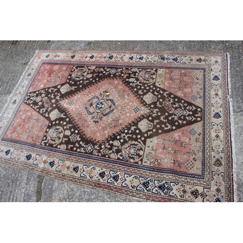 618 - A Qashqai rug with animals in a central medallion and multi-borders in shades of brown, red, blue, b... 