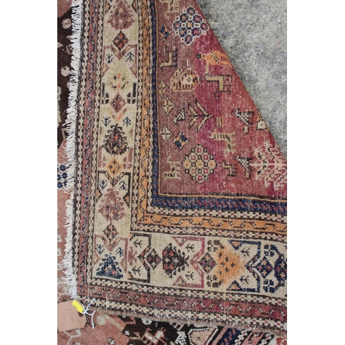 618 - A Qashqai rug with animals in a central medallion and multi-borders in shades of brown, red, blue, b... 