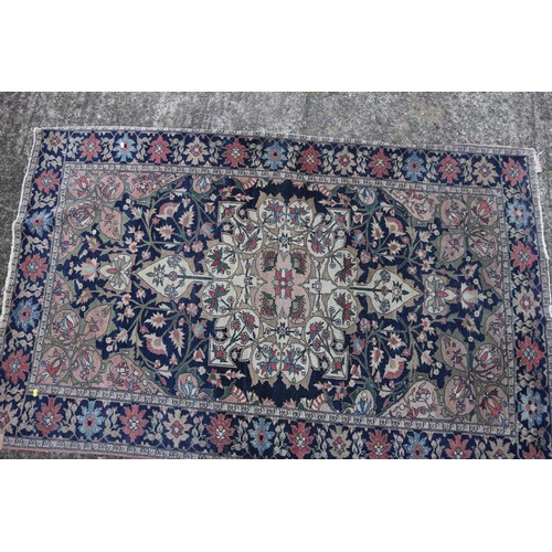 622 - A Persian city rug with all-over flower and scroll design, on a blue ground and multi-boarded in sha... 