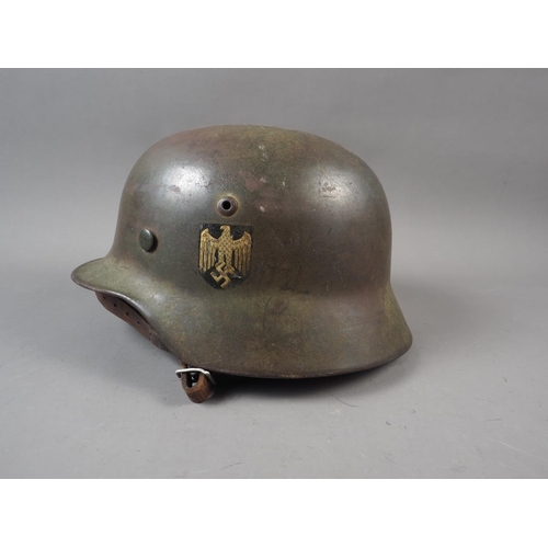 155 - A 1940 Wehrmacht steel helmet M35, with double decal, some rust, with leather liner and chin strap, ... 