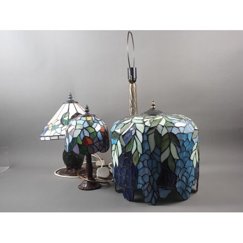 230 - Three Tiffany style leaded glass table lamps, on 