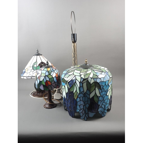 230 - Three Tiffany style leaded glass table lamps, on 