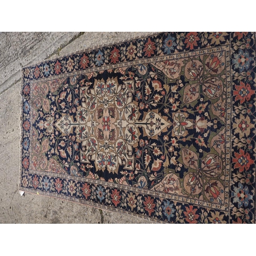 622 - A Persian city rug with all-over flower and scroll design, on a blue ground and multi-boarded in sha... 