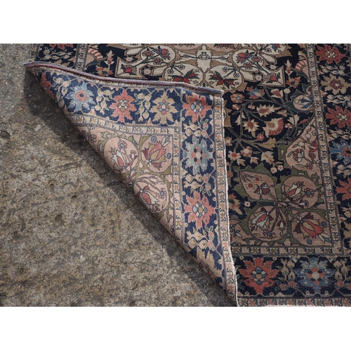 622 - A Persian city rug with all-over flower and scroll design, on a blue ground and multi-boarded in sha... 