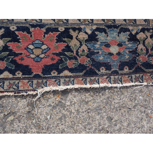 622 - A Persian city rug with all-over flower and scroll design, on a blue ground and multi-boarded in sha... 