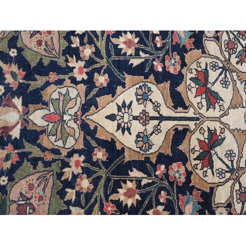 622 - A Persian city rug with all-over flower and scroll design, on a blue ground and multi-boarded in sha... 