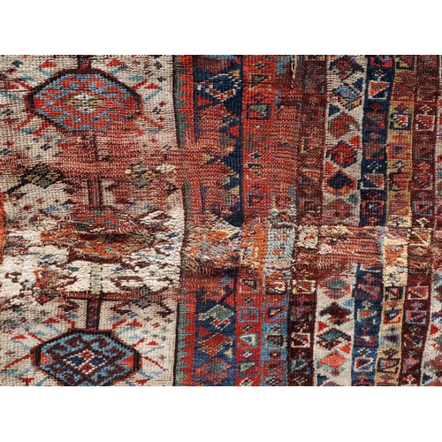 623 - An antique Caucasian rug with floral centre on a purple ground, 88