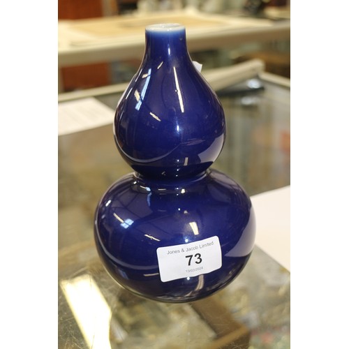 73 - A Chinese monochrome blue glazed double gourd vase, 7 1/4