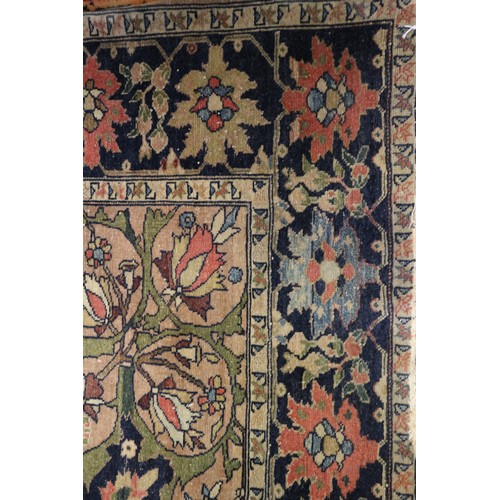 622 - A Persian city rug with all-over flower and scroll design, on a blue ground and multi-boarded in sha... 