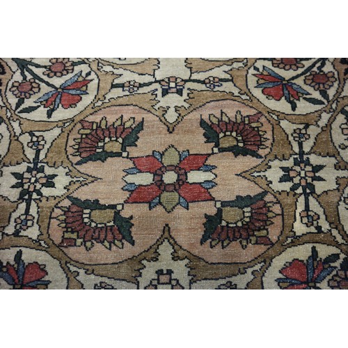 622 - A Persian city rug with all-over flower and scroll design, on a blue ground and multi-boarded in sha... 