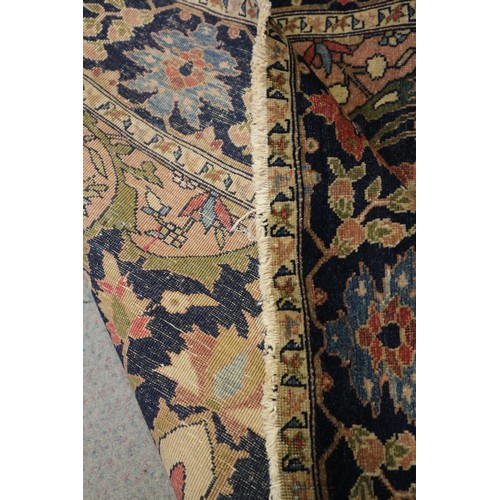 622 - A Persian city rug with all-over flower and scroll design, on a blue ground and multi-boarded in sha... 