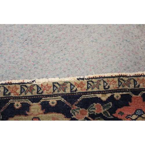 622 - A Persian city rug with all-over flower and scroll design, on a blue ground and multi-boarded in sha... 