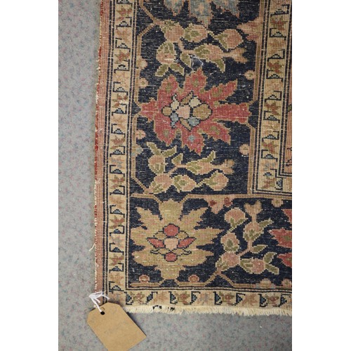 622 - A Persian city rug with all-over flower and scroll design, on a blue ground and multi-boarded in sha... 