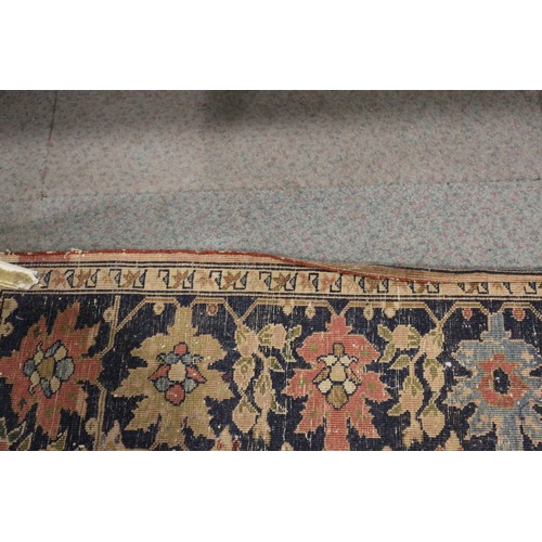 622 - A Persian city rug with all-over flower and scroll design, on a blue ground and multi-boarded in sha... 