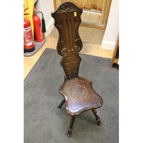 220 - A circular brass topped folding table, a child's elm and beech stick back chair, and a carved oak sp... 