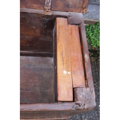 422 - An early 18th century Hanseatic planked oak coffer, the interior fitted candle box, on stile support... 