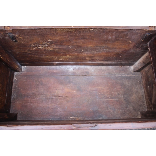 422 - An early 18th century Hanseatic planked oak coffer, the interior fitted candle box, on stile support... 