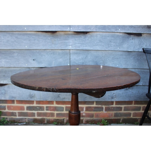 426 - An 18th century oak circular top occasional table, on turned column and tripod splay support, 32