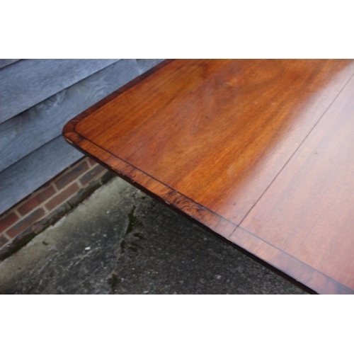 427 - A late Georgian mahogany and rosewood banded rectangular tilt top breakfast table, on turned column ... 