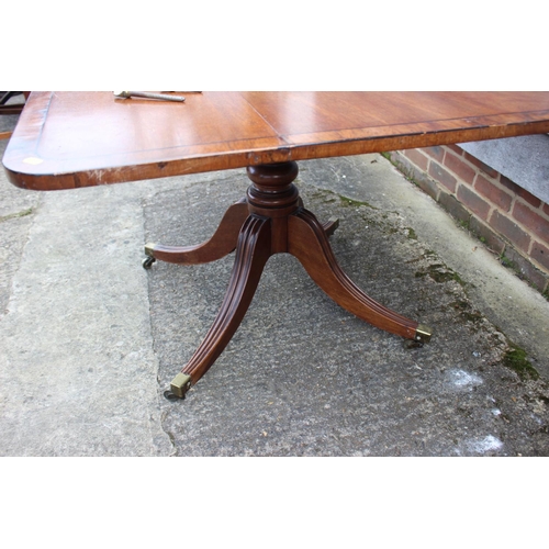 427 - A late Georgian mahogany and rosewood banded rectangular tilt top breakfast table, on turned column ... 