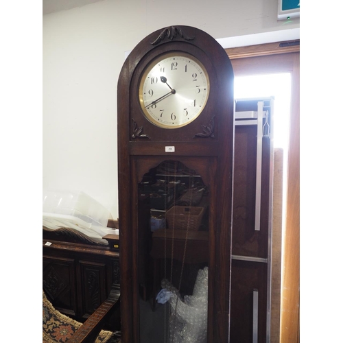 464 - An early 20th century oak cased arch topped long case clock with silvered dial and Arabic numerals, ... 