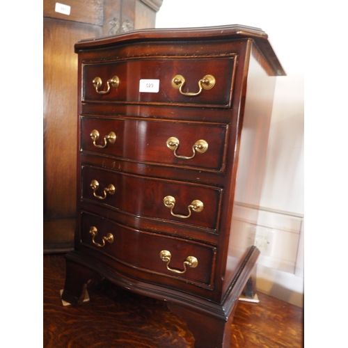 510 - A mahogany serpentine front bedside chest of four drawers, 16