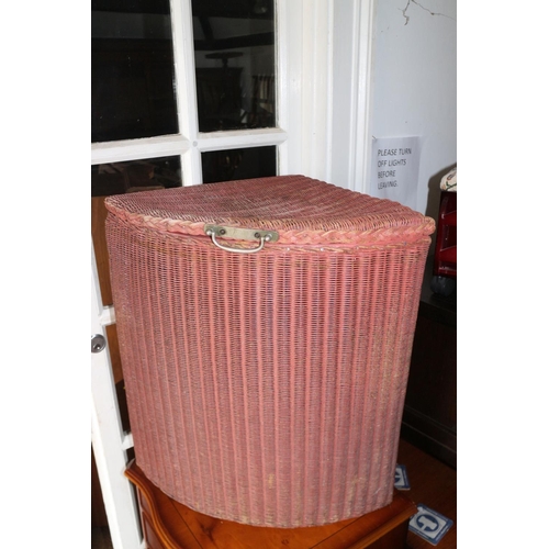 540 - A Lloyd Loom quadrant linen basket with original pink paint, 22