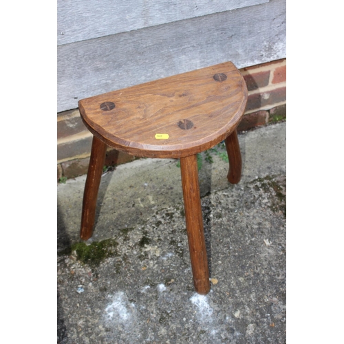 541 - An ash and birch milking stool with semicircular seat, 13