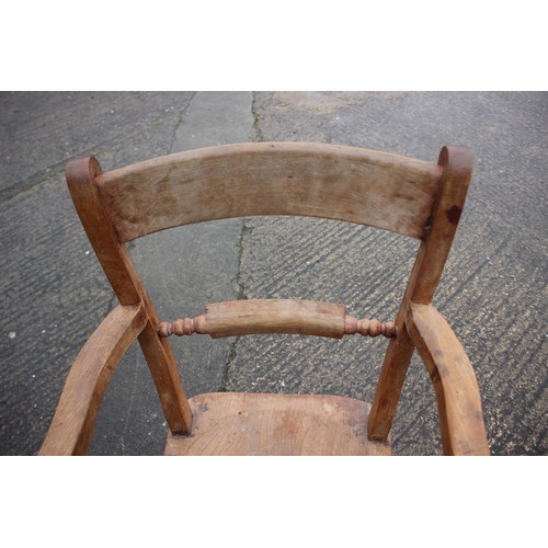 419 - An Oxford bar back elbow chair with elm seat, on turned supports