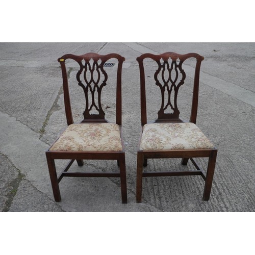 429 - A pair of late Georgian mahogany shaped pierced twin splat dining chairs with serpentine stuffed ove... 