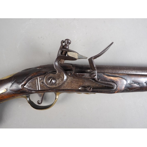 146 - An 18th century flintlock pistol with brass mounts and monogram to stock barrel, 11 1/2