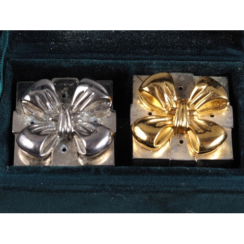 214 - Two pairs of silver plated and gilt pepperettes, in cases