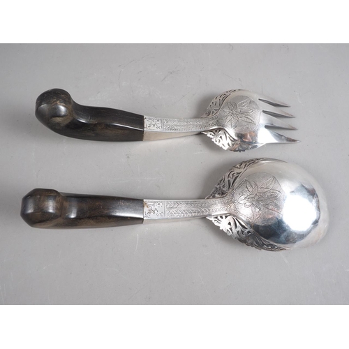 242 - A pair of Eastern, white metal salad servers with horn pistol grip handles