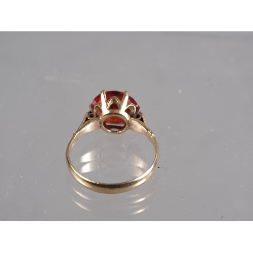 254 - A 9ct gold and synthetic sapphire single stone cocktail ring, size M/N, 2.8g