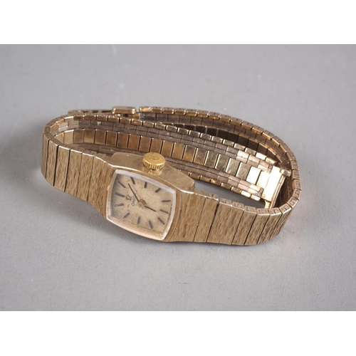 286 - A lady's Omega wristwatch with 9ct gold case and strap with textured decoration, 27.5g gross