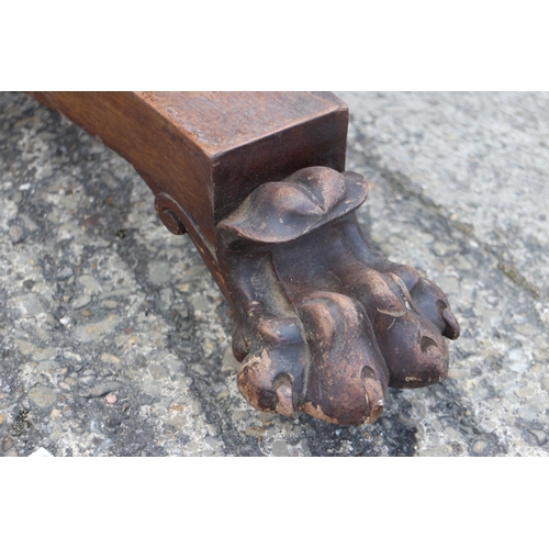 415 - A mid Victorian mahogany circular tilt top dining table, on faceted column, triform base and lion pa... 