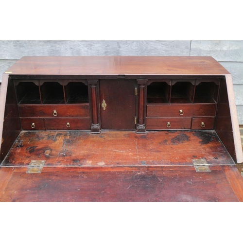 458 - A mid 18th century mahogany two-section fall front bureau, the interior fitted drawers and pigeon ho... 