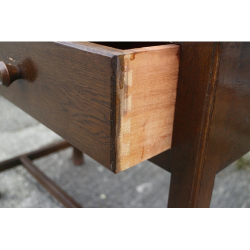 496 - A 1960s oak side table, fitted two drawers, on moulded stretchered supports, 39