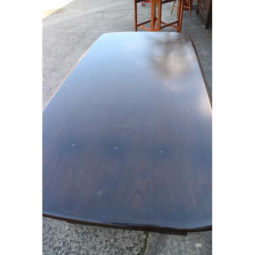 500 - An Ercol dark elm Old Colonial refectory type fixed top dining table, on pierced panel end supports,... 